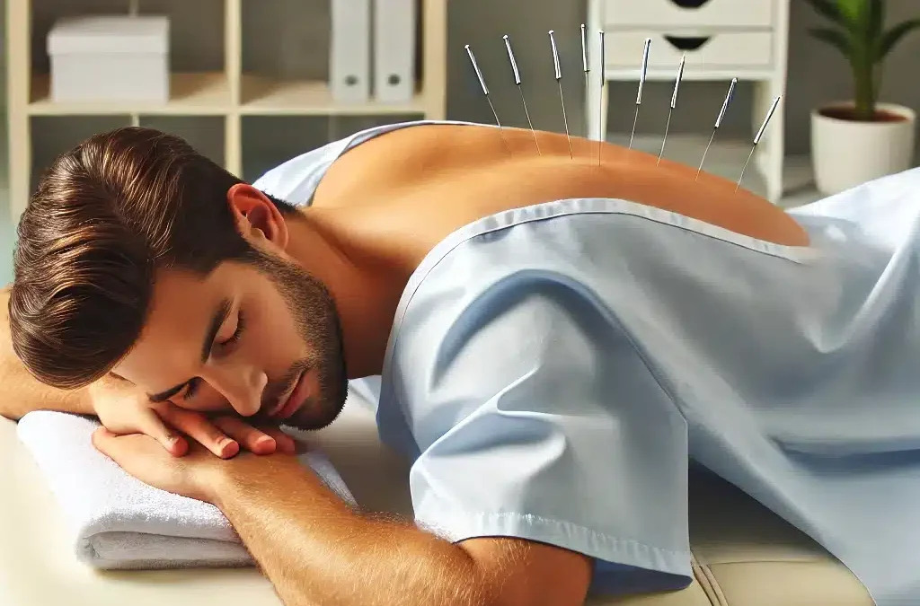 Acupuncture is being shown on a man lying on his stomach, wearing a hospital gown open at the back, receiving medical acupuncture on his upper back in a clean and professional environment. Acupuncture is depicted as a therapeutic and relaxing treatment.